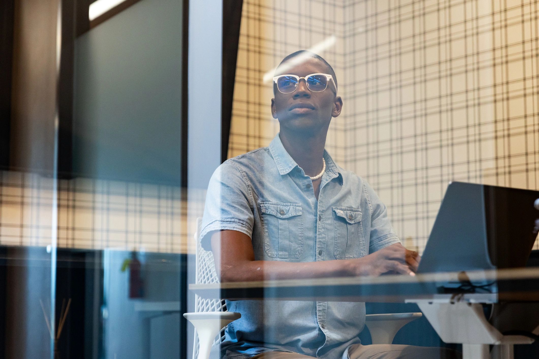 Software engineer working on a laptop in a modern office